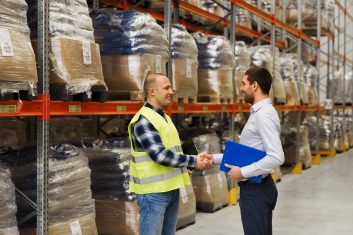 worker and businessmen with clipboard at warehouse